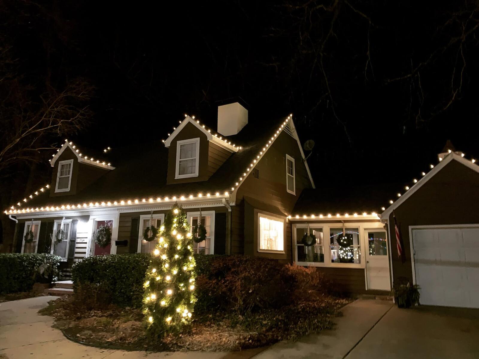Cottage with lit spruce